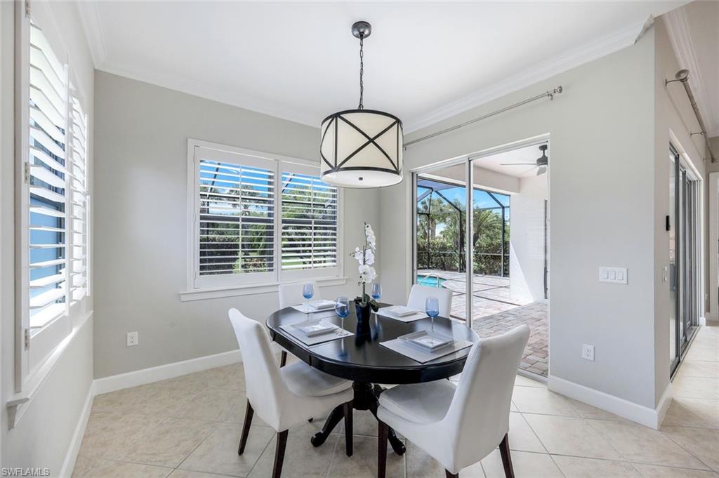 9062 Limestone Lane Naples, FL 34120 - Photo 12 of 48 a dining room with furniture and window