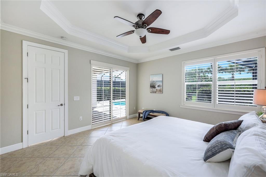 9062 Limestone Lane Naples, FL 34120 - Photo 14 of 48 a bed sitting in a bedroom next to a window