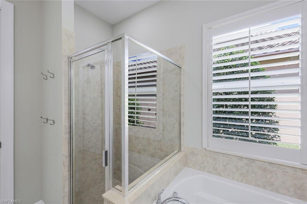 9062 Limestone Lane Naples, FL 34120 - Photo 16 of 48 a bathroom with a bathtub and shower