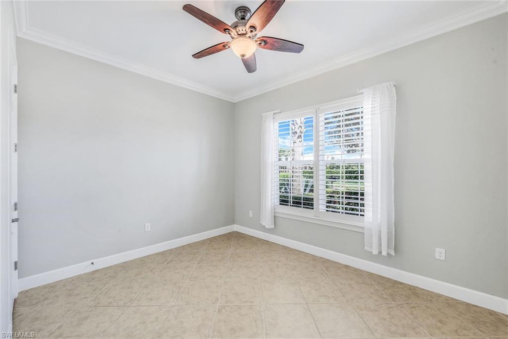 9062 Limestone Lane Naples, FL 34120 - Photo 17 of 48 a view of a room with a ceiling fan and a large window