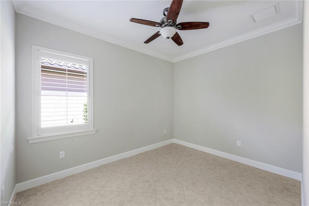 9062 Limestone Lane Naples, FL 34120 - Photo 19 of 48 an empty room with a window and a fan