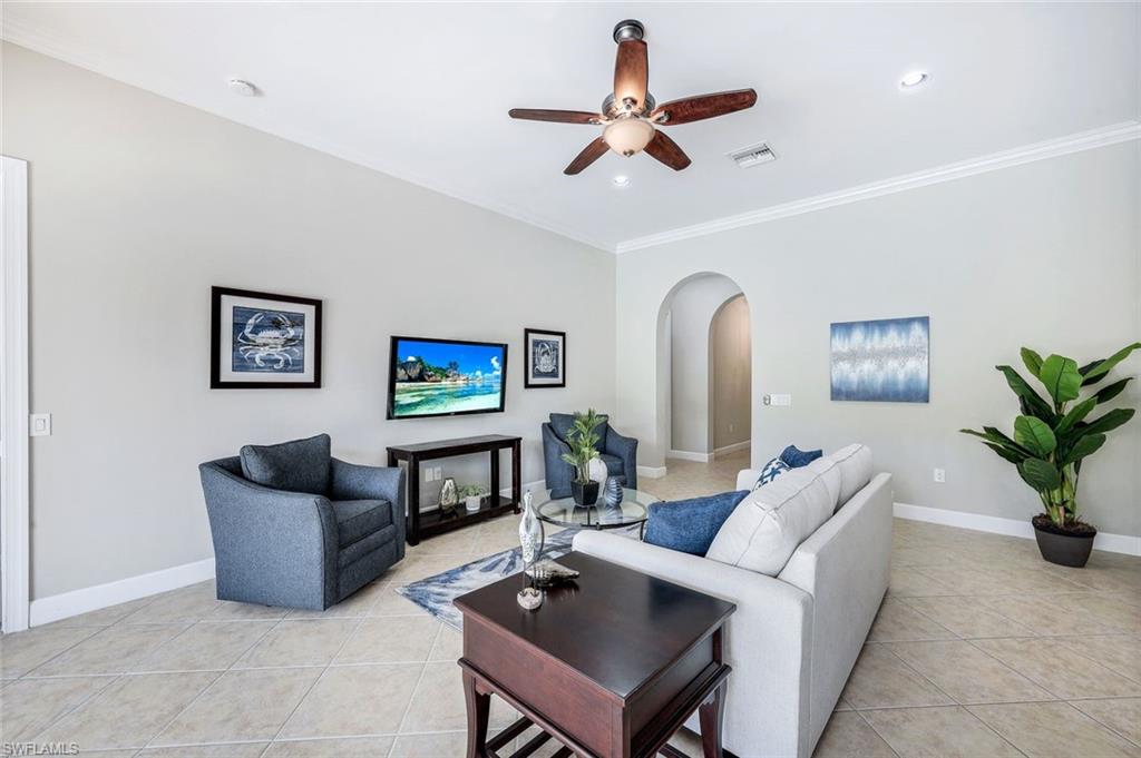 9062 Limestone Lane Naples, FL 34120 - Photo 5 of 48 a living room with furniture and a potted plant