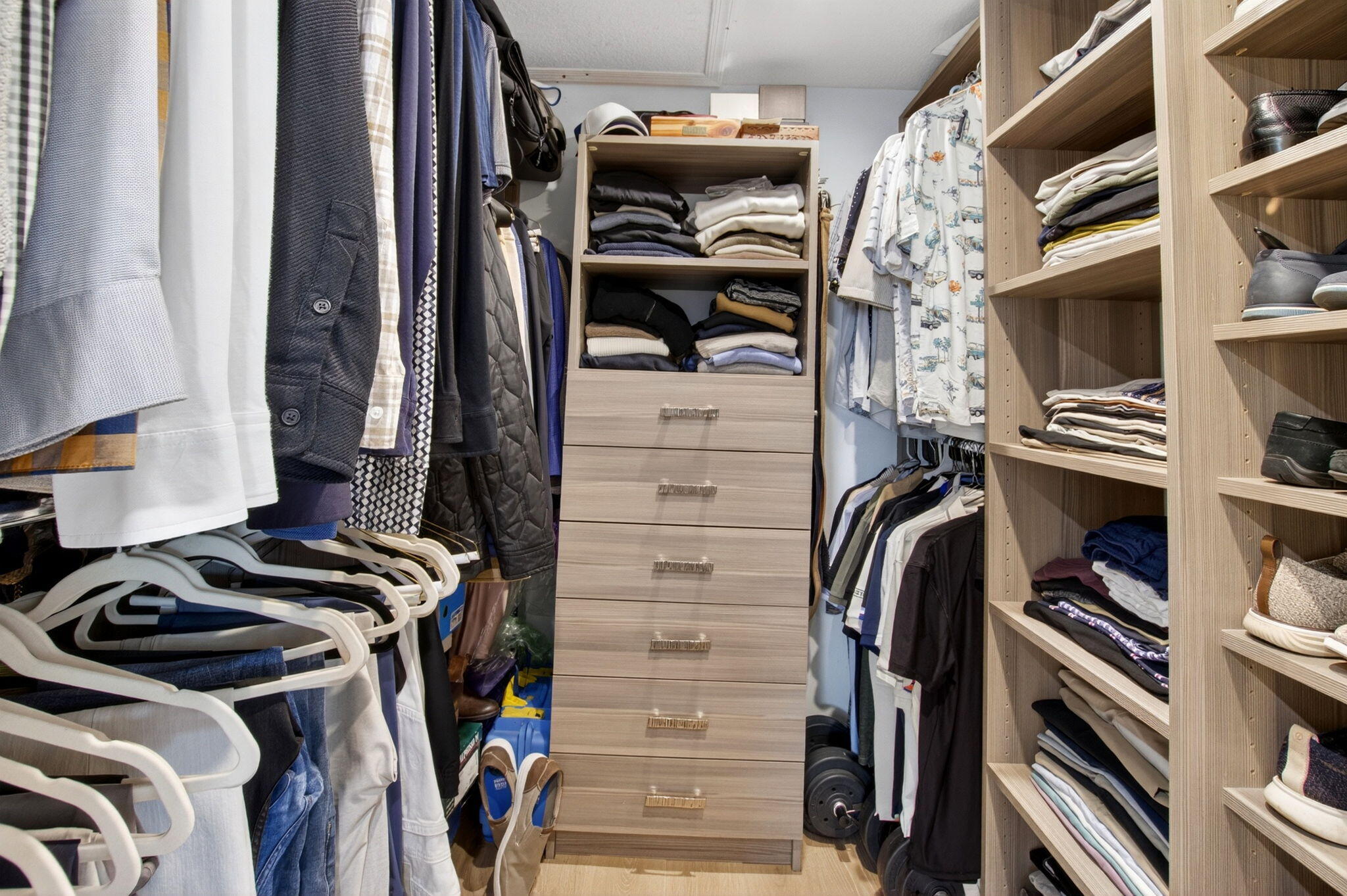 950 De Soto Road, Unit 5A Boca Raton, FL 33432 - Photo 58 of 98 a view of walk in closet with clothes and shoes