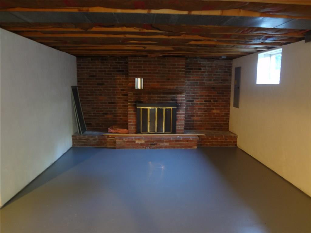 303 Madison Heights Road New Stanton, PA 15672 - Photo 20 of 23 Lower Level Family Room (partially finished) with Wood Burning Fireplace.