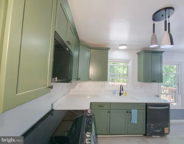 an empty room with a ceiling fan and a window