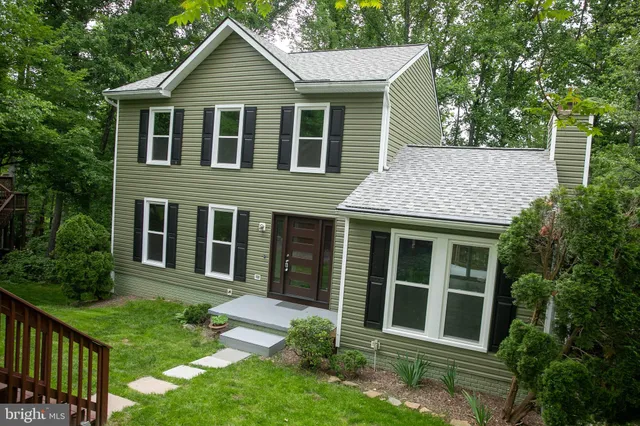 a front view of a house with a garden