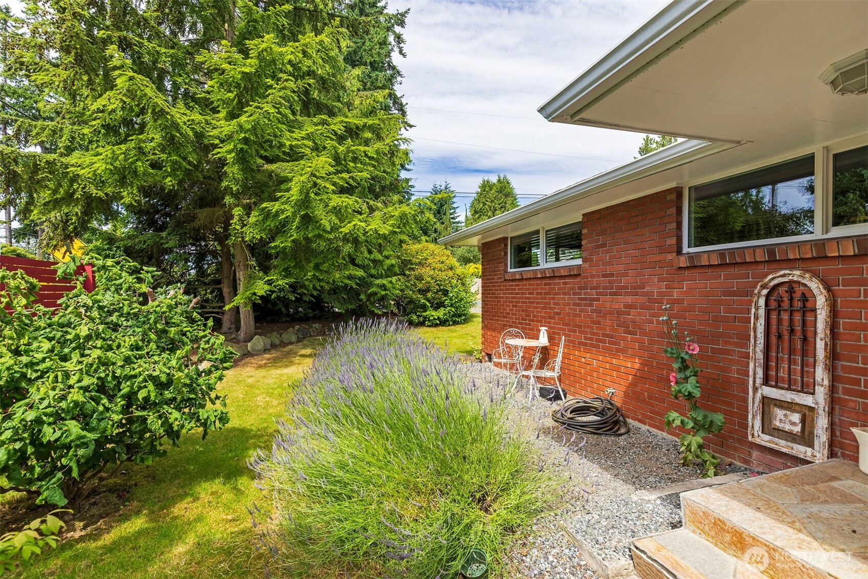 7923 220th Street Southwest Edmonds, WA 98026 - Photo 2 of 40 a view of a backyard with plants and a patio