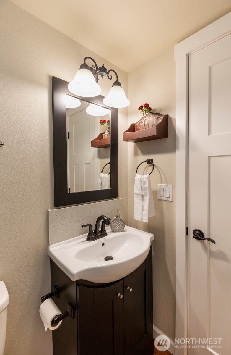7923 220th Street Southwest Edmonds, WA 98026 - Photo 25 of 40 a bathroom with a sink and a mirror