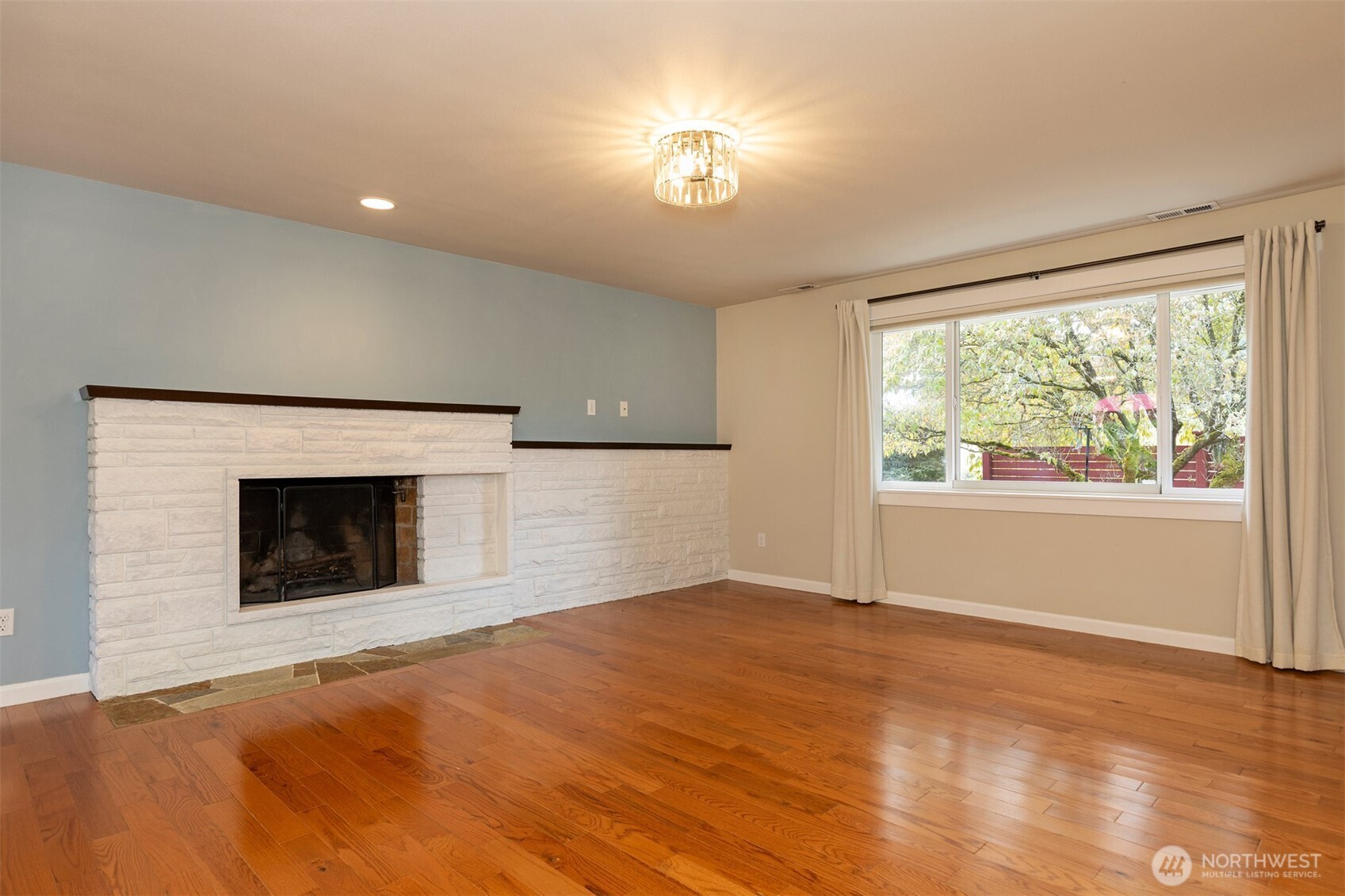 7923 220th Street Southwest Edmonds, WA 98026 - Photo 28 of 40 a view of empty room with a fireplace and window