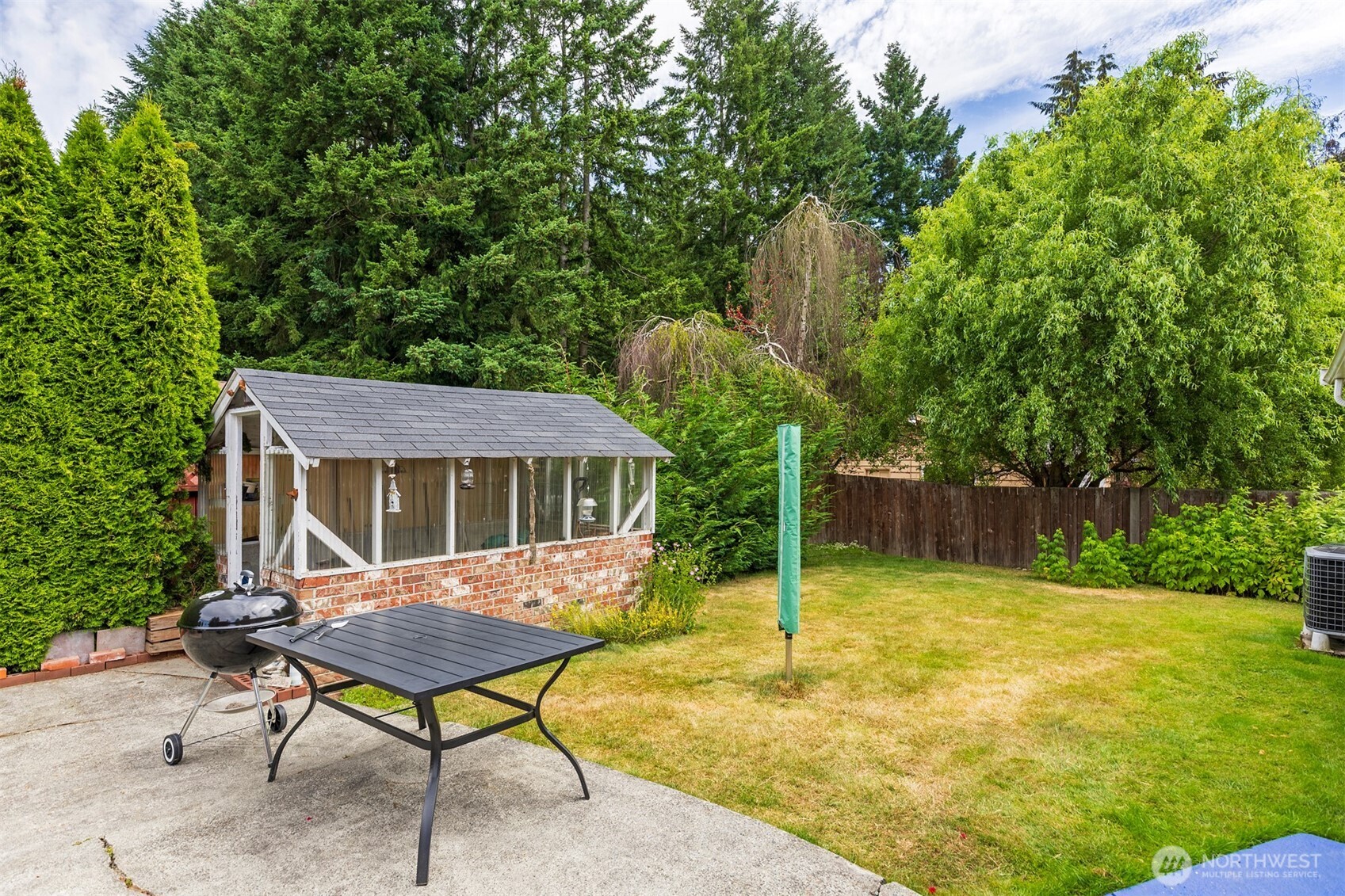7923 220th Street Southwest Edmonds, WA 98026 - Photo 36 of 40 a backyard of a house with table and chairs