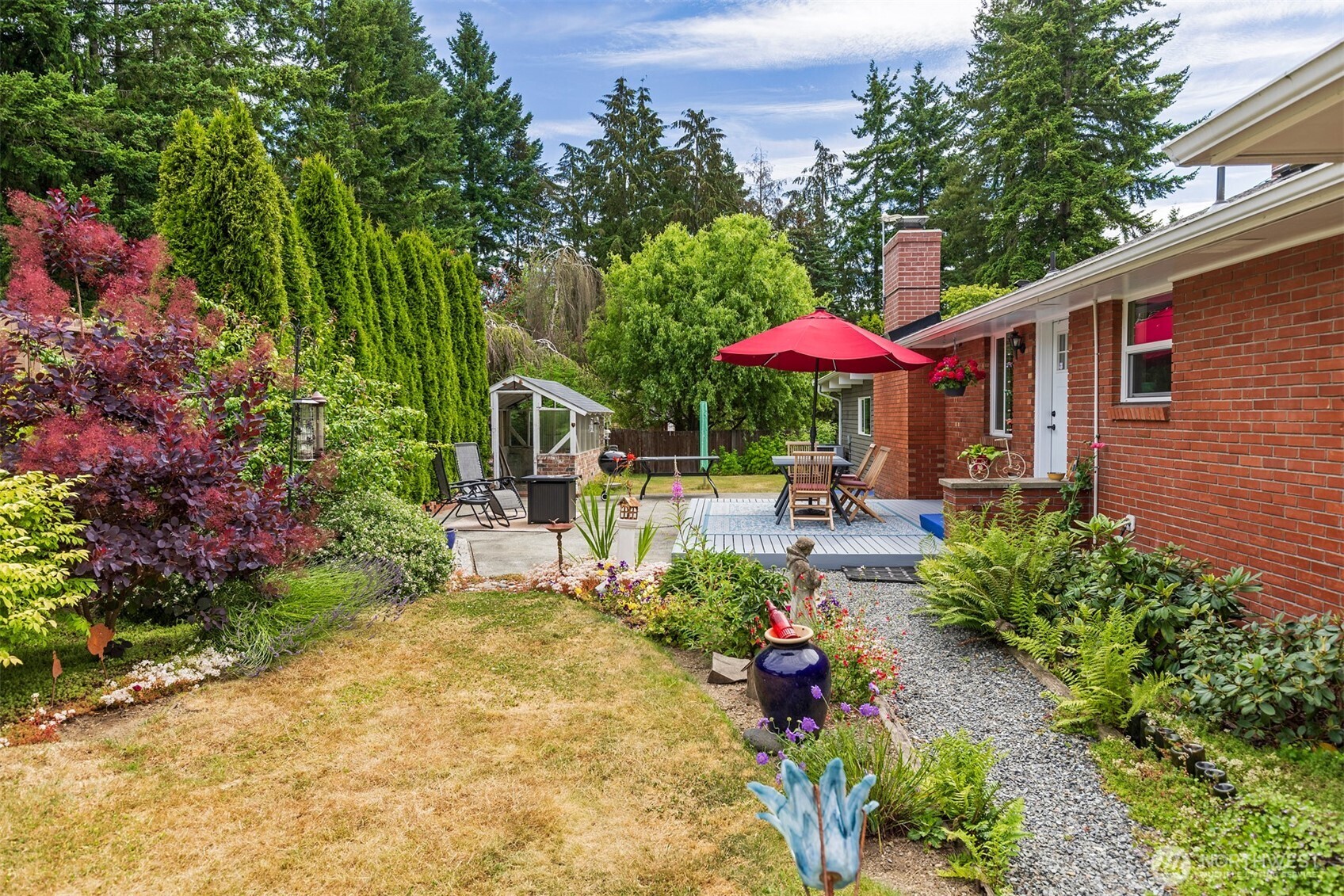 7923 220th Street Southwest Edmonds, WA 98026 - Photo 38 of 40 a view of a patio with furniture and a table and chairs under an umbrella