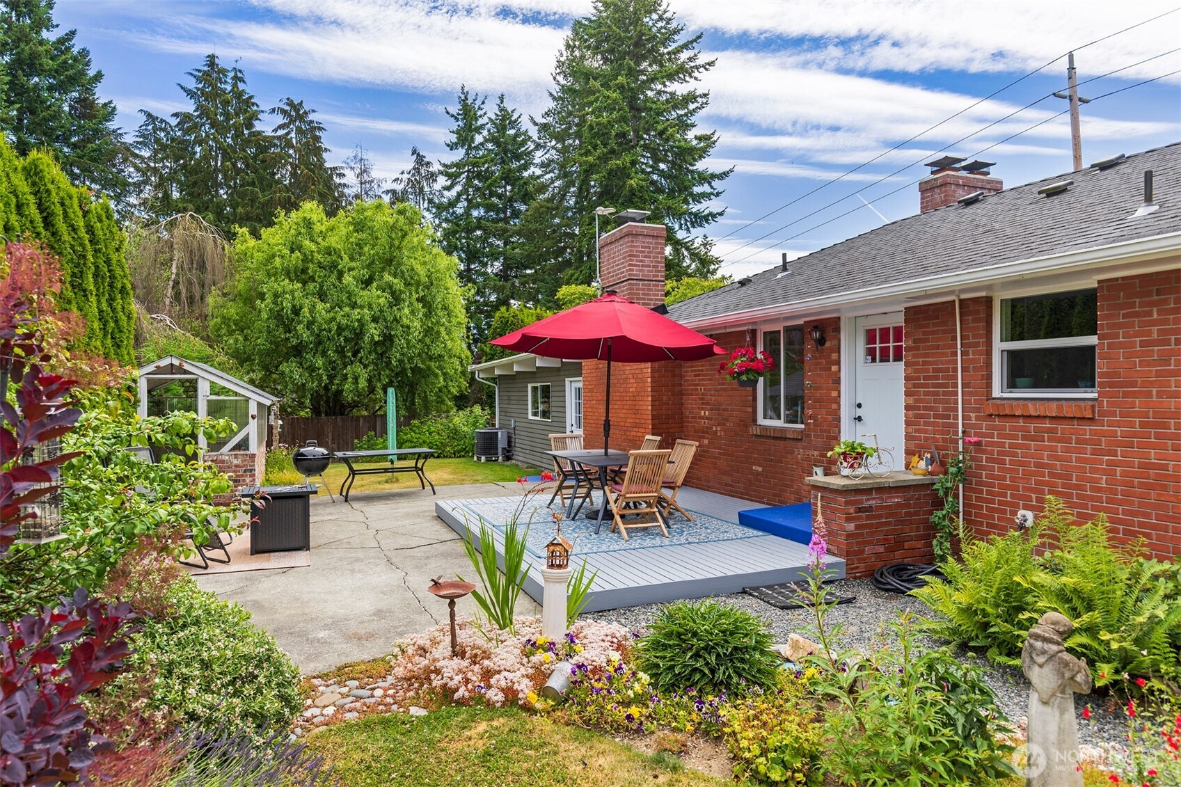 7923 220th Street Southwest Edmonds, WA 98026 - Photo 39 of 40 a view of a patio with a table and chairs under an umbrella