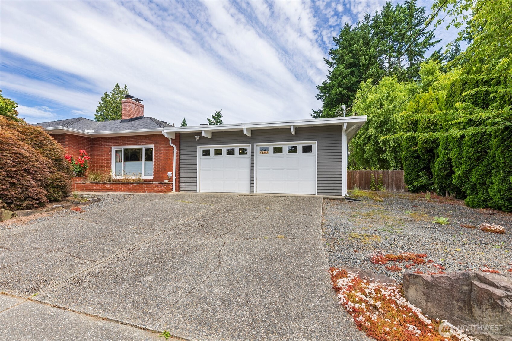 7923 220th Street Southwest Edmonds, WA 98026 - Photo 4 of 40 a front view of a house with a yard and garage