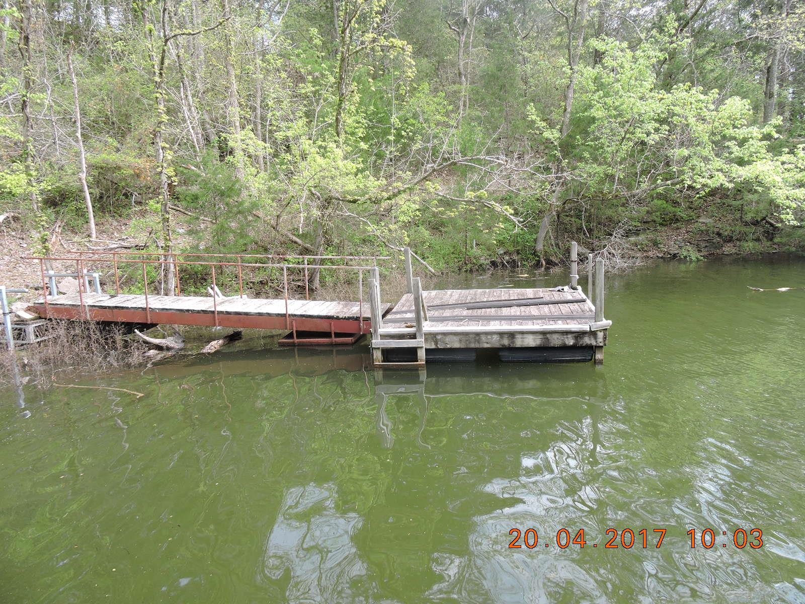 295 Lake Hill Road Manchester, TN 37355 - Photo 18 of 18 a view of a lake with boats and trees in the background