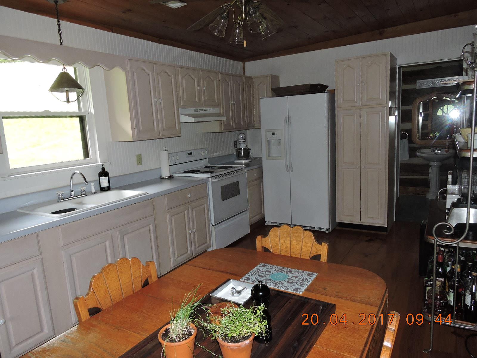 295 Lake Hill Road Manchester, TN 37355 - Photo 10 of 18 a kitchen with stainless steel appliances granite countertop a sink dishwasher a refrigerator a stove and white cabinets with wooden floor