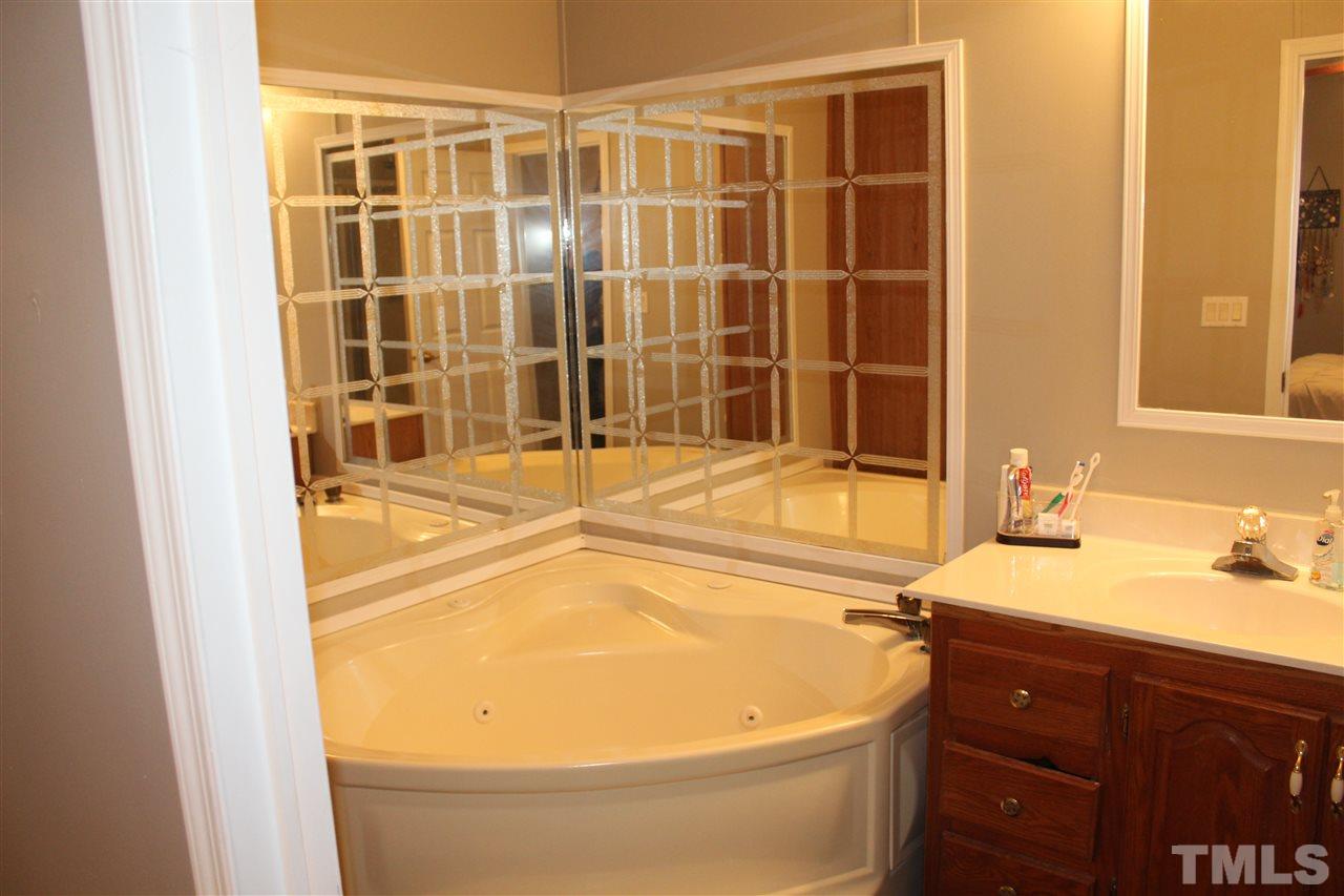 1189 Little Mountain Road Stem, NC 27581 - Photo 14 of 17 a bathroom with a tub and a sink