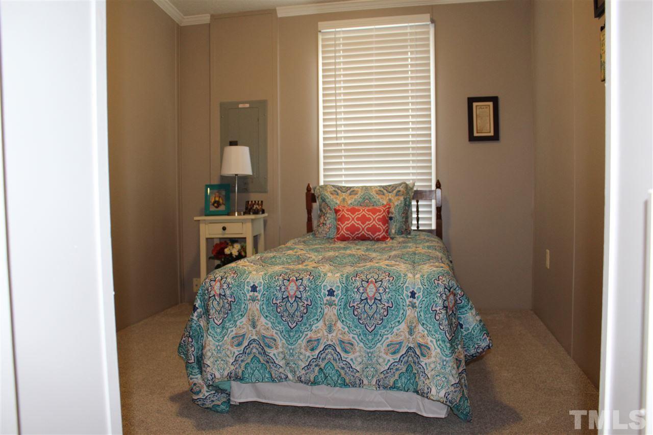 1189 Little Mountain Road Stem, NC 27581 - Photo 16 of 17 a bedroom with a bed and a window