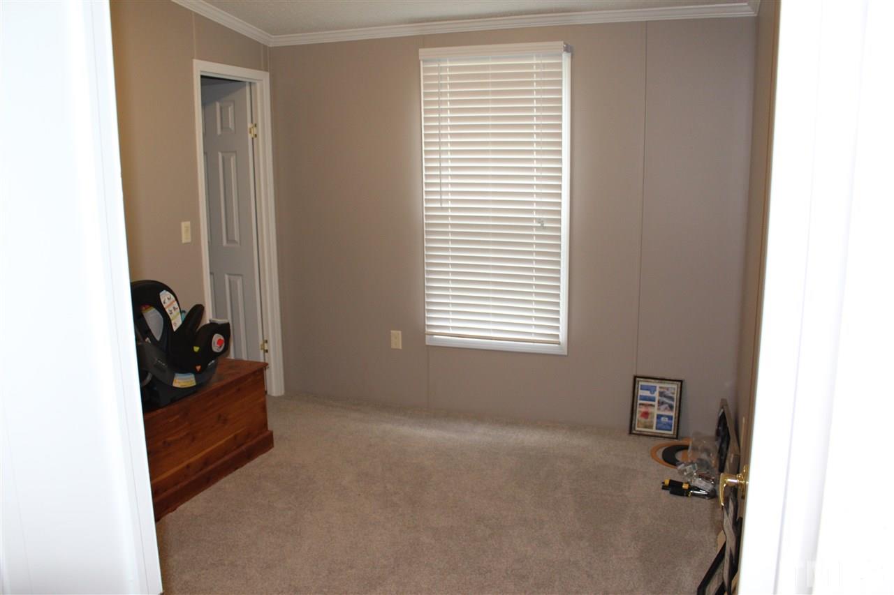 1189 Little Mountain Road Stem, NC 27581 - Photo 17 of 17 a room that has a bed and a window