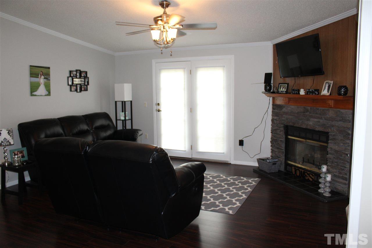 1189 Little Mountain Road Stem, NC 27581 - Photo 8 of 17 a living room with furniture and a flat screen tv