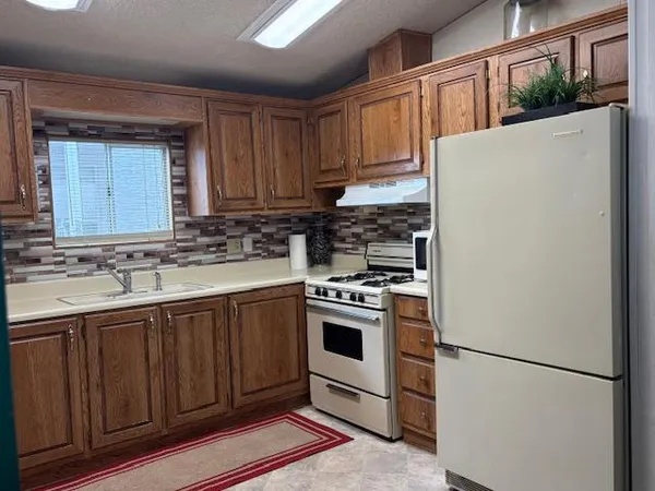 a kitchen with a white cabinets and white appliances
