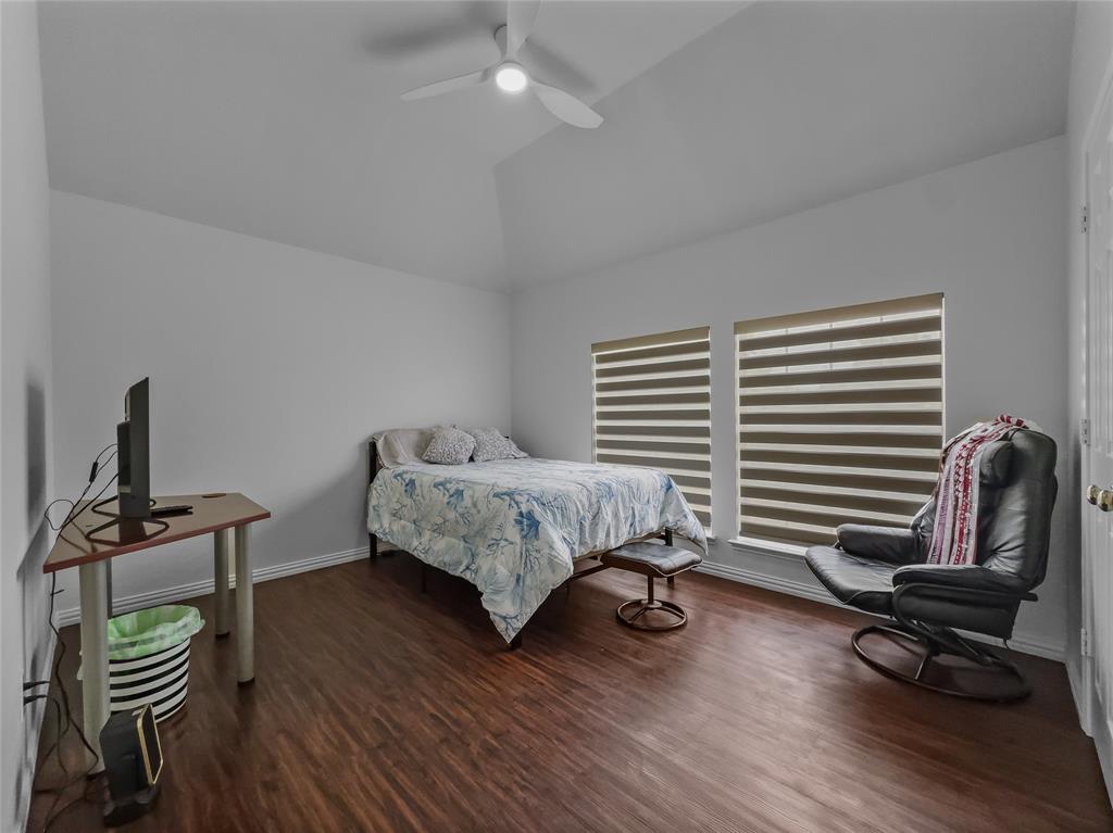 2317 Wellesly Road Rowlett, TX 75089 - Photo 29 of 39 a bedroom with a bed and wooden floor