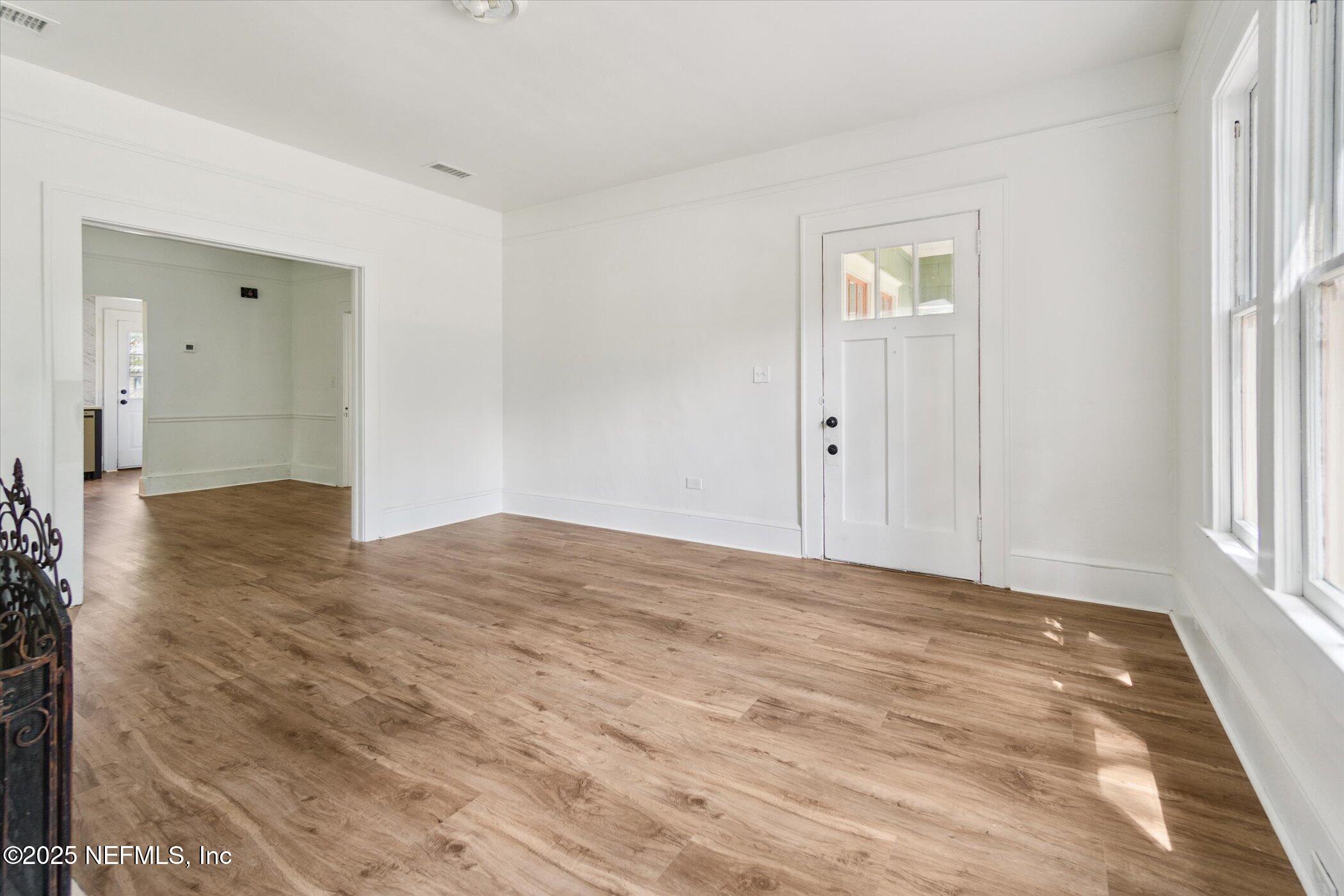 3849 Valencia Road Jacksonville, FL 32205 - Photo 11 of 30 a view of empty room with wooden floor and fan