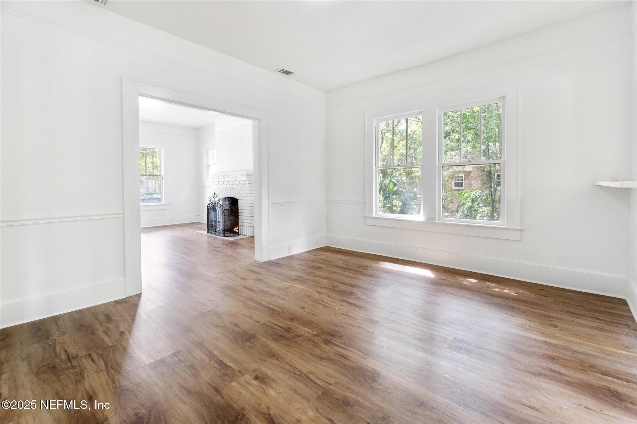 3849 Valencia Road Jacksonville, FL 32205 - Photo 14 of 30 an empty room with wooden floor and windows
