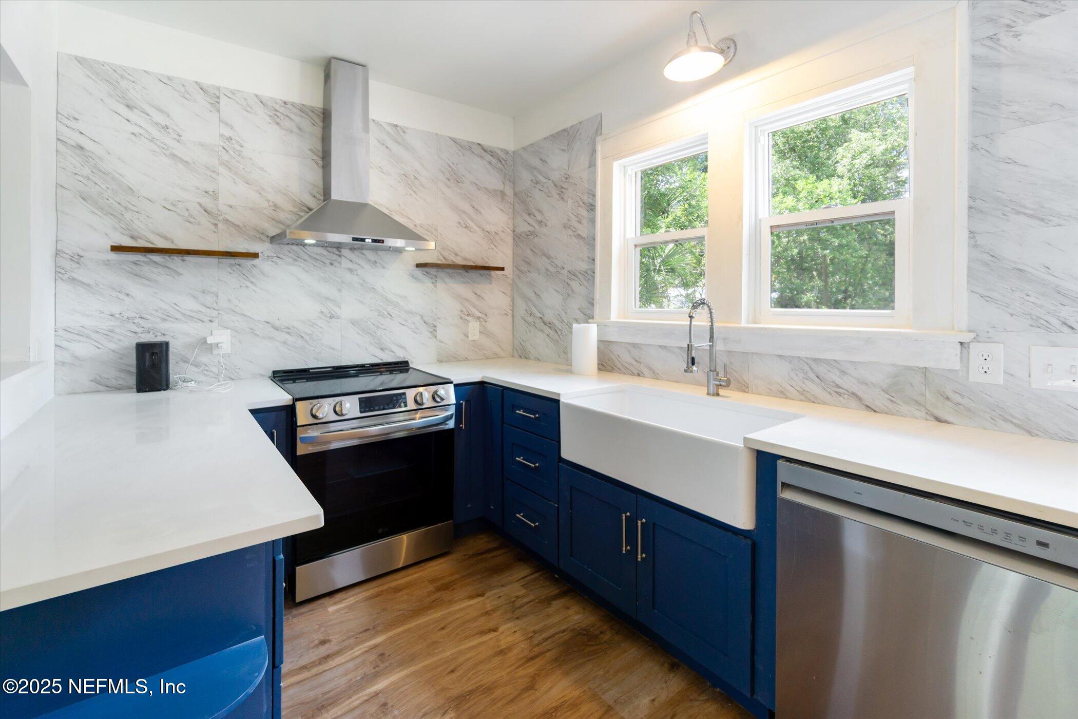 3849 Valencia Road Jacksonville, FL 32205 - Photo 15 of 30 a kitchen with stainless steel appliances sink a stove and a window