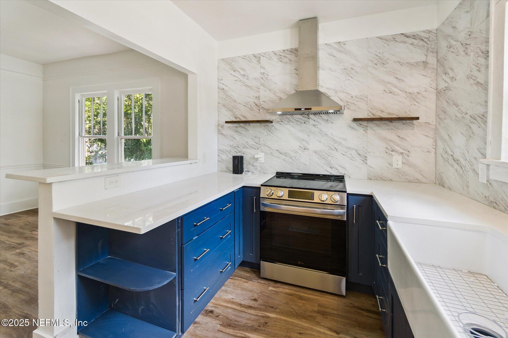 3849 Valencia Road Jacksonville, FL 32205 - Photo 16 of 30 a kitchen with stainless steel appliances granite countertop a stove and a refrigerator