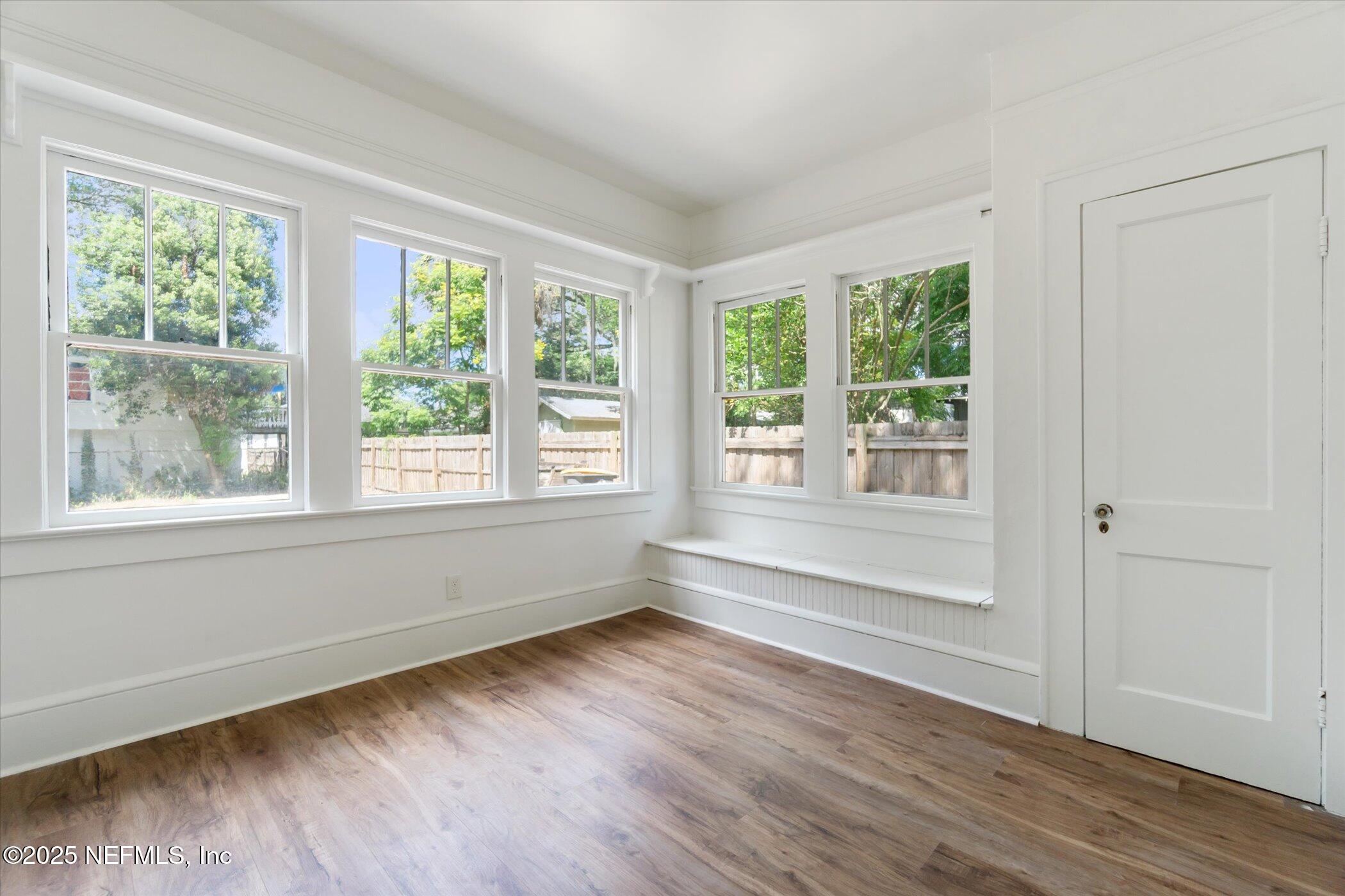 3849 Valencia Road Jacksonville, FL 32205 - Photo 22 of 30 a view of wooden floor and windows in a room