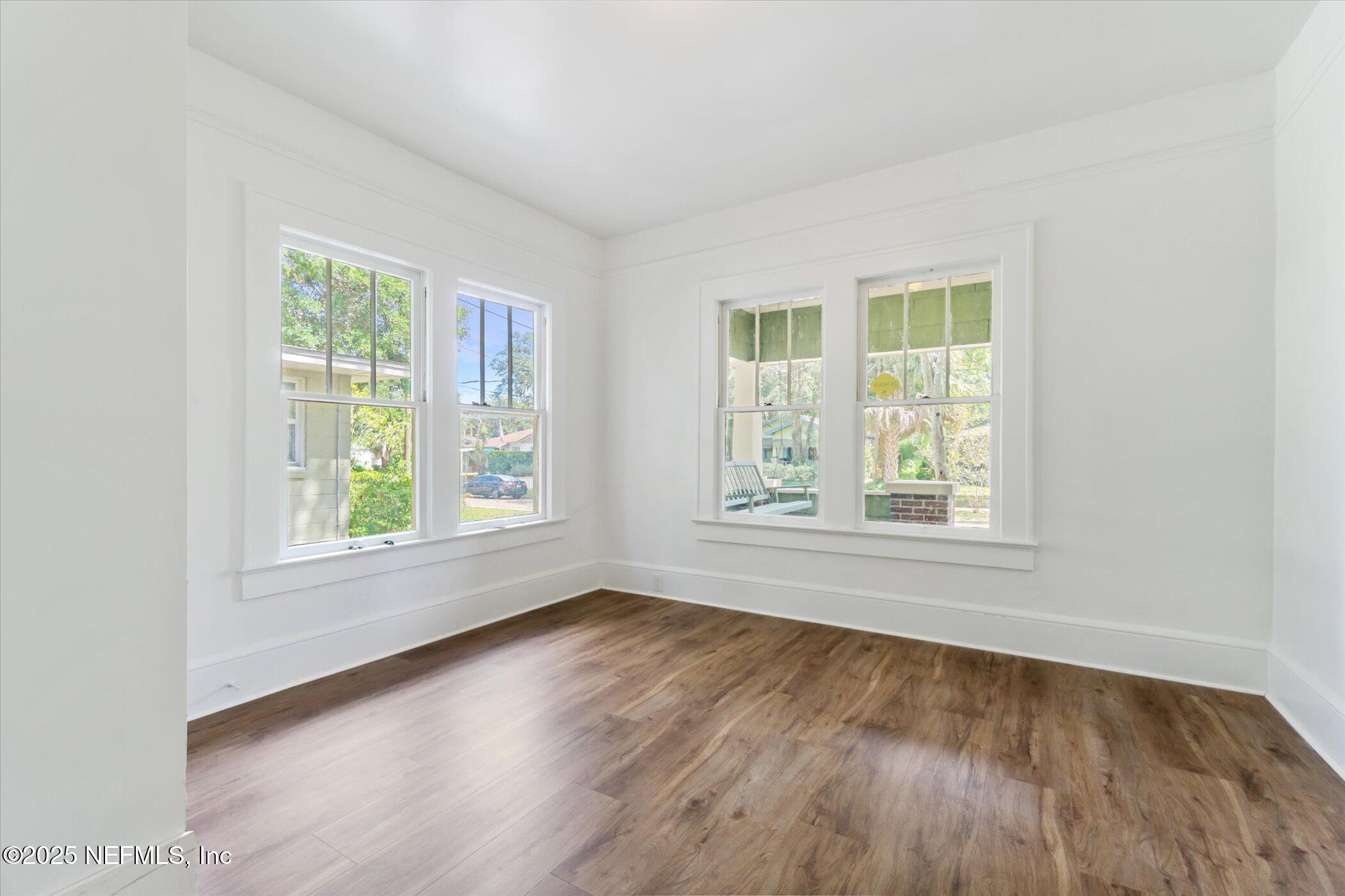 3849 Valencia Road Jacksonville, FL 32205 - Photo 24 of 30 an empty room with wooden floor and windows