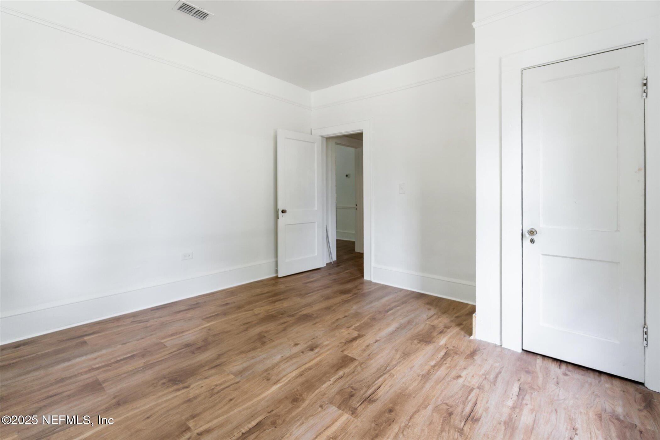 3849 Valencia Road Jacksonville, FL 32205 - Photo 25 of 30 a view of an empty room with wooden floor
