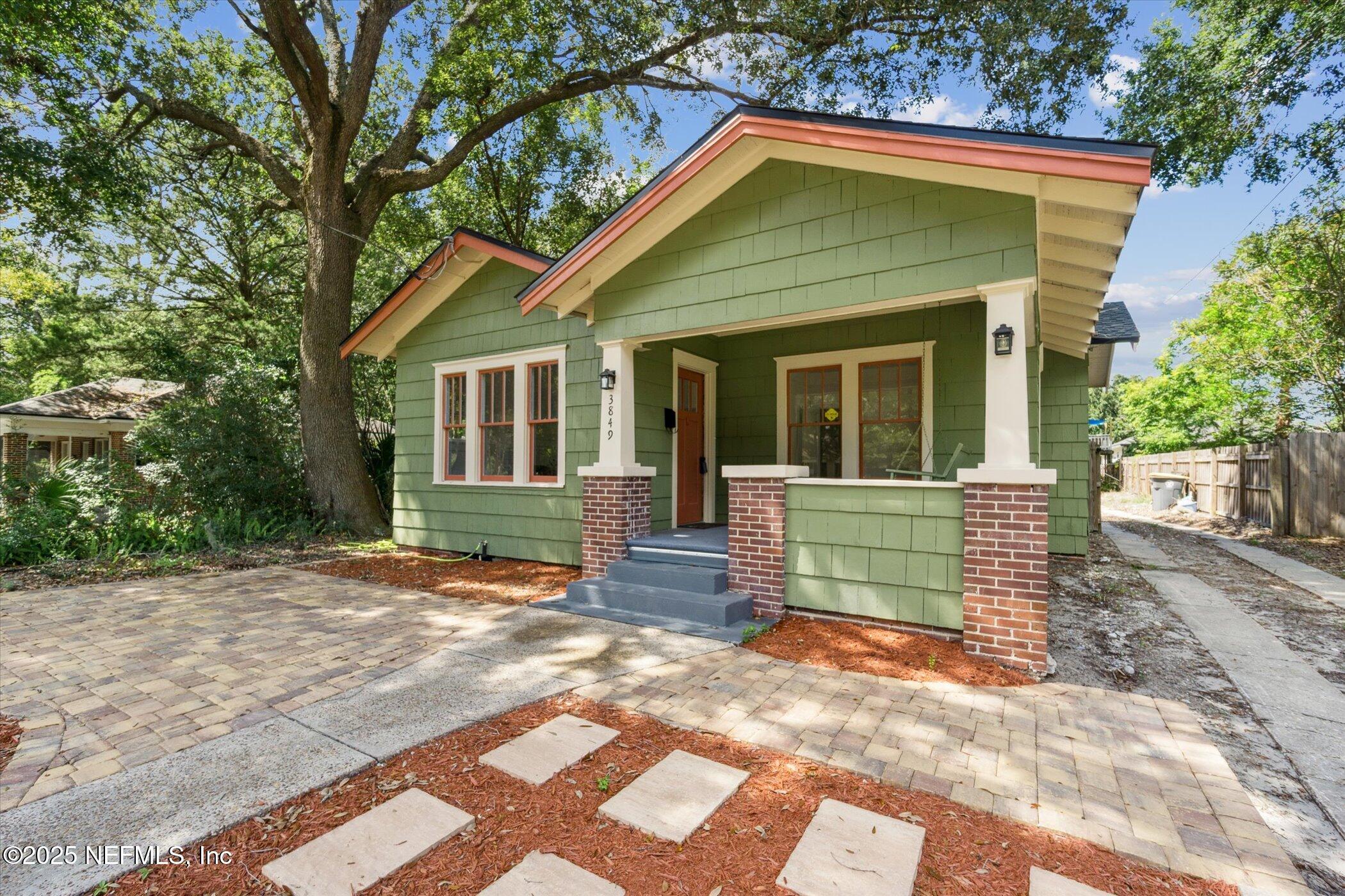 3849 Valencia Road Jacksonville, FL 32205 - Photo 6 of 30 a front view of a house with a garden