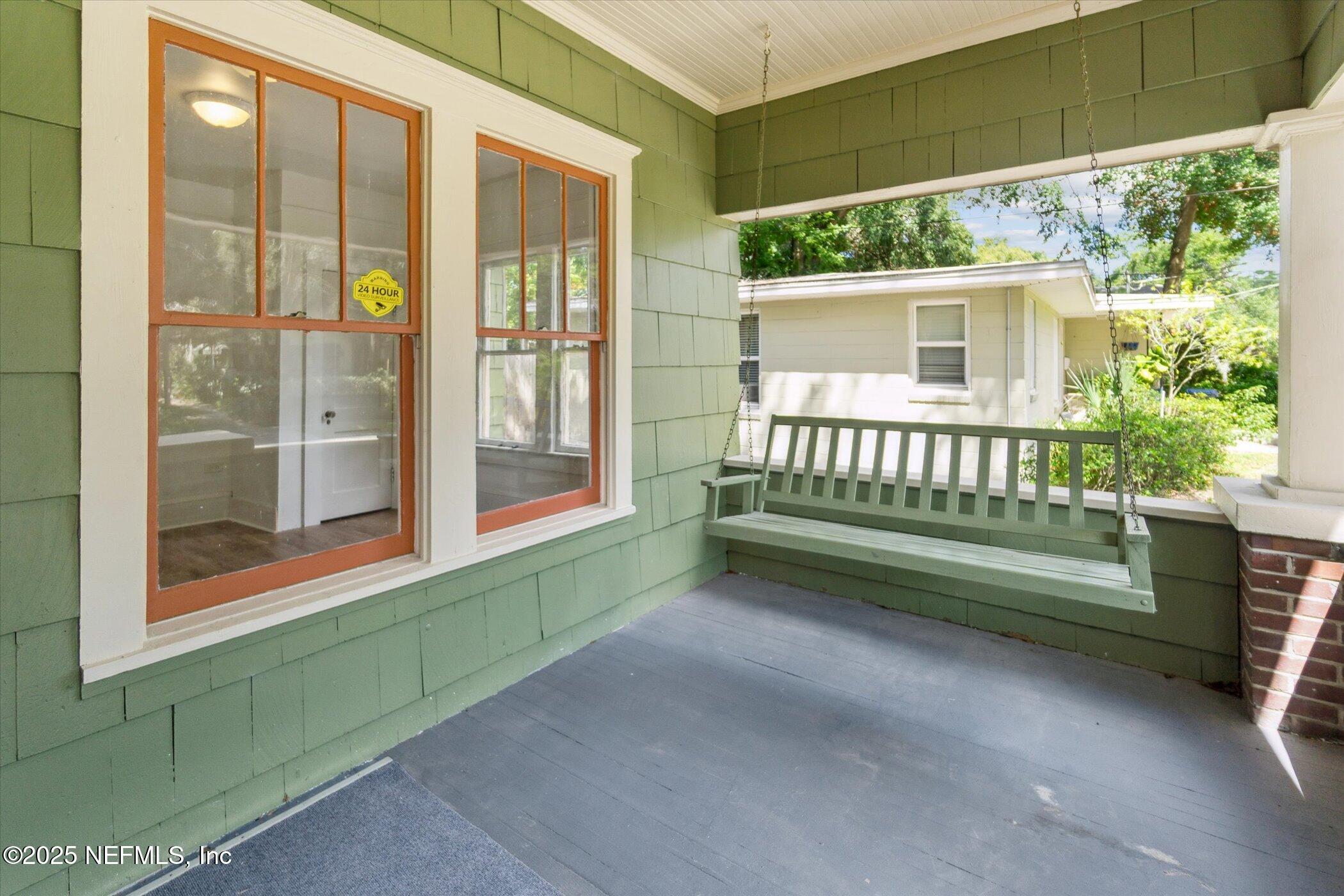 3849 Valencia Road Jacksonville, FL 32205 - Photo 8 of 30 a view of a porch with a floor to ceiling window and a yard