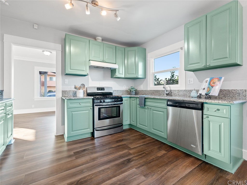 1096 Stanley Avenue Long Beach, CA 90804 - Photo 11 of 33 a kitchen with granite countertop wooden floors and a sink