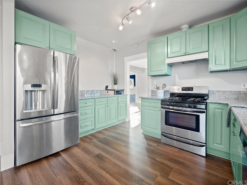 1096 Stanley Avenue Long Beach, CA 90804 - Photo 14 of 33 a kitchen with granite countertop stainless steel appliances and wooden cabinets