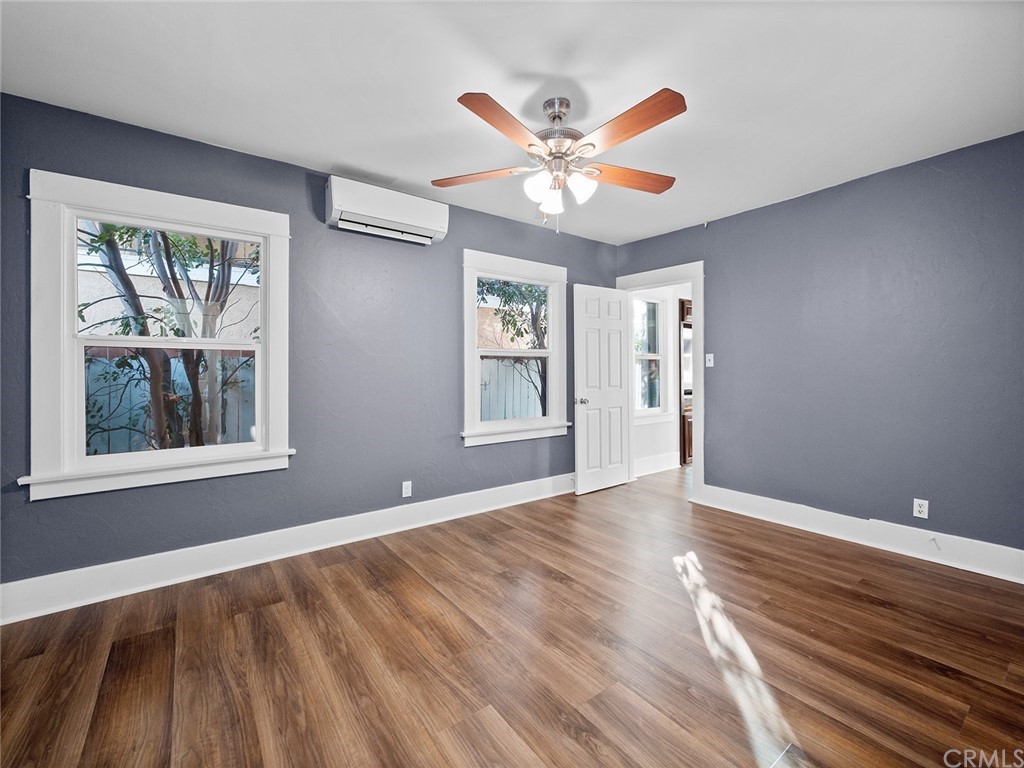 1096 Stanley Avenue Long Beach, CA 90804 - Photo 17 of 33 a view of an empty room with window and wooden floor