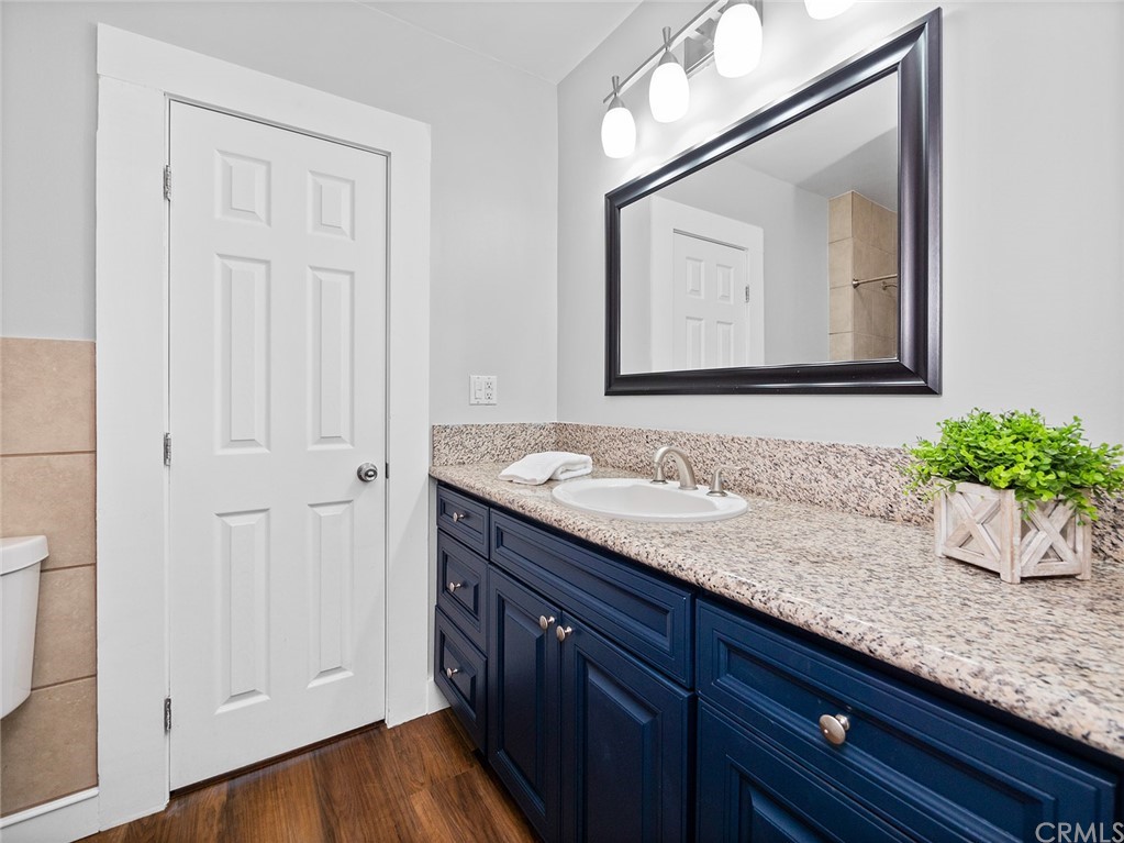 1096 Stanley Avenue Long Beach, CA 90804 - Photo 19 of 33 a bathroom with a granite countertop double vanity sink and mirror