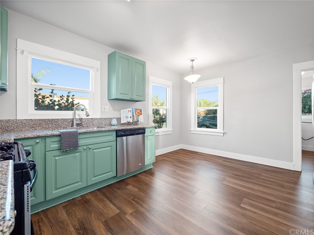 1096 Stanley Avenue Long Beach, CA 90804 - Photo 9 of 33 a kitchen with cabinets and wooden floor