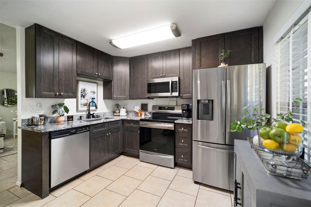 11305 Silverleaf Court Riverview, FL 33579 - Photo 22 of 39 a kitchen with stainless steel appliances granite countertop a refrigerator a stove a sink and a microwave