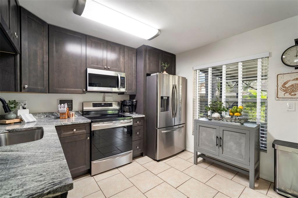 11305 Silverleaf Court Riverview, FL 33579 - Photo 23 of 39 a kitchen with stainless steel appliances granite countertop a refrigerator stove top oven and sink