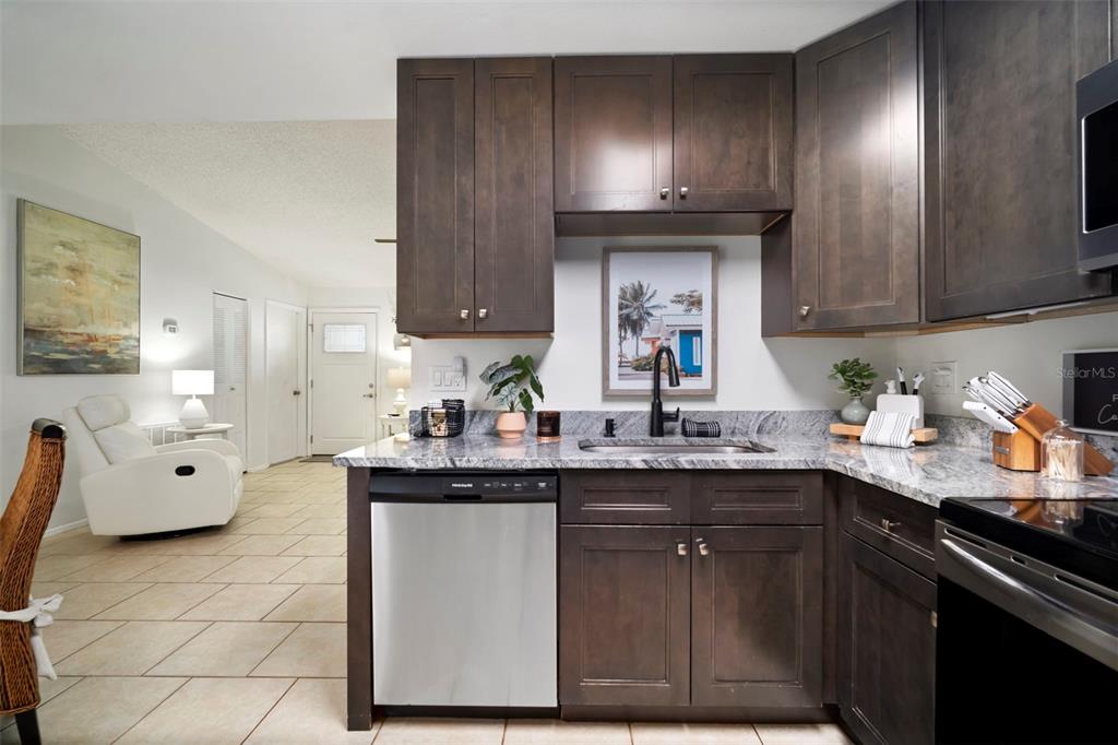 11305 Silverleaf Court Riverview, FL 33579 - Photo 26 of 39 a kitchen with stainless steel appliances granite countertop a sink stove and cabinets