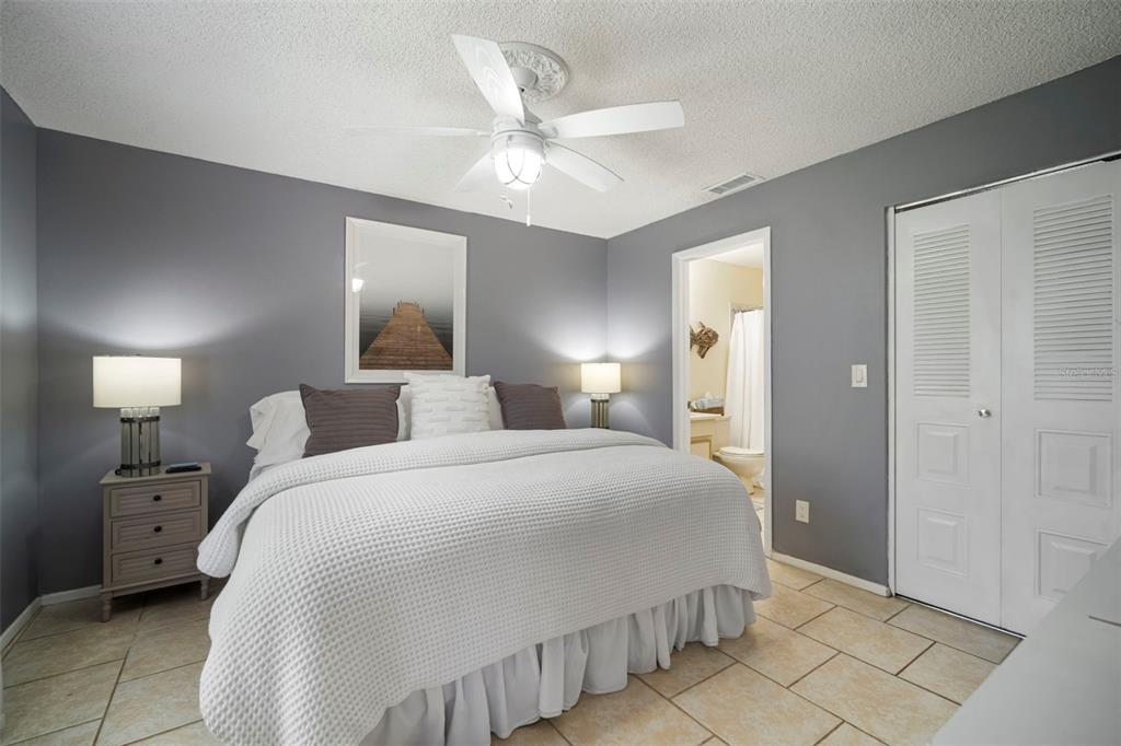 11305 Silverleaf Court Riverview, FL 33579 - Photo 27 of 39 a bedroom with a large bed and a chandelier