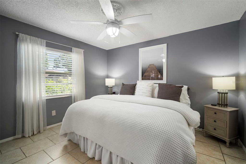 11305 Silverleaf Court Riverview, FL 33579 - Photo 28 of 39 a bedroom with a large bed and a chandelier