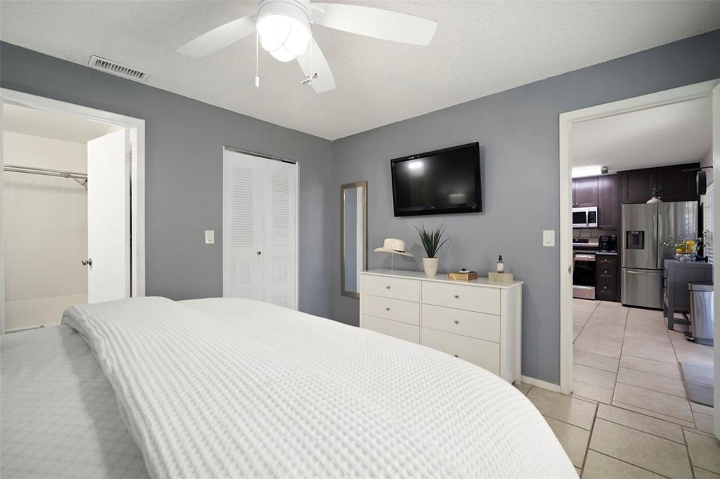 11305 Silverleaf Court Riverview, FL 33579 - Photo 29 of 39 a large bedroom with a large bed and a flat screen tv