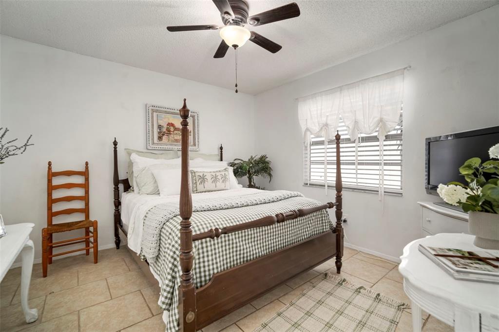 11305 Silverleaf Court Riverview, FL 33579 - Photo 8 of 39 a bedroom with a bed and a chandelier