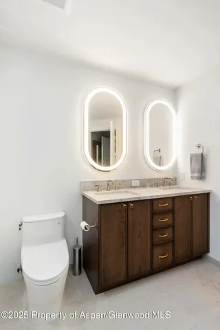 a bedroom with a bed window and a flat screen tv