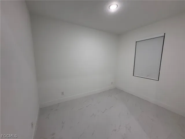 an empty room with a empty space and mirror