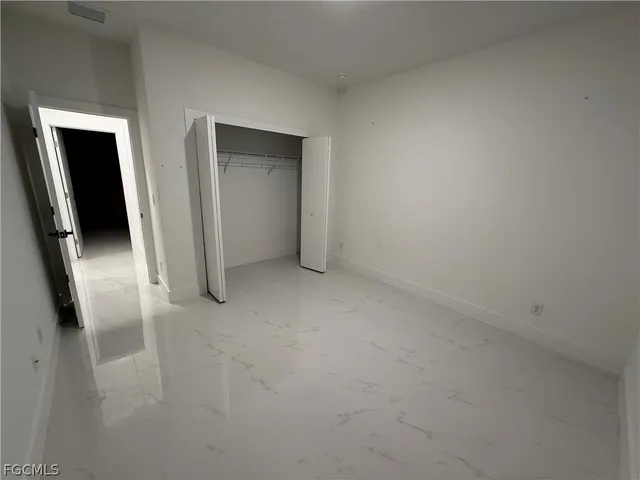 an empty room with a mirror