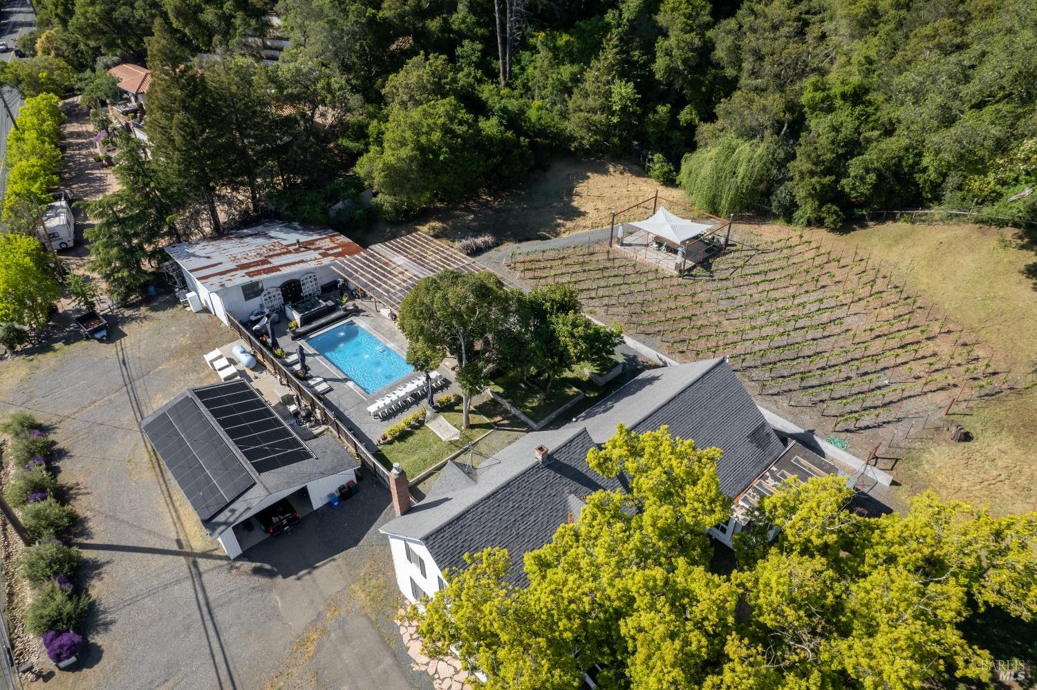 Drone shot looking west. A virtual playground with beautiful pool and picnic areas. Even in the vineyard.